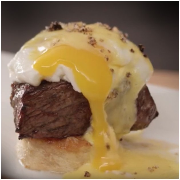 Meat topped with runny egg yolk