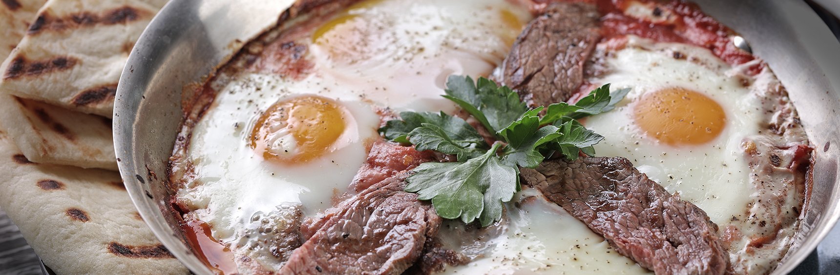 Beef and eggs in a pan