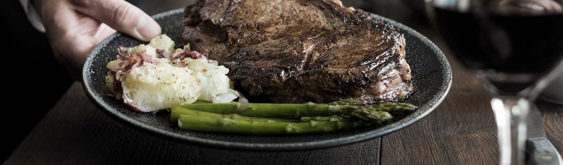 Steak, asparagus, and mashed potatoes on a plate