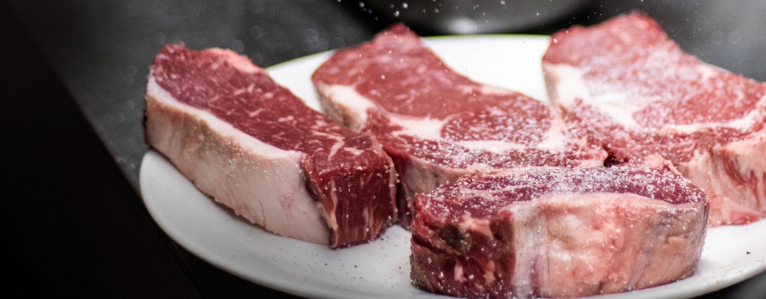 Salt sprinkled on cut of beef