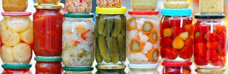 Pickled vegetable jars stacked up on top of one another