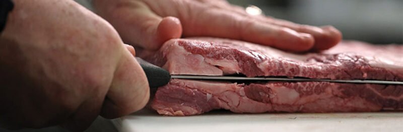 Chef cutting beef