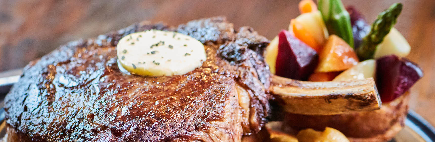 Close-up of a plated steak with a side of potatoes
